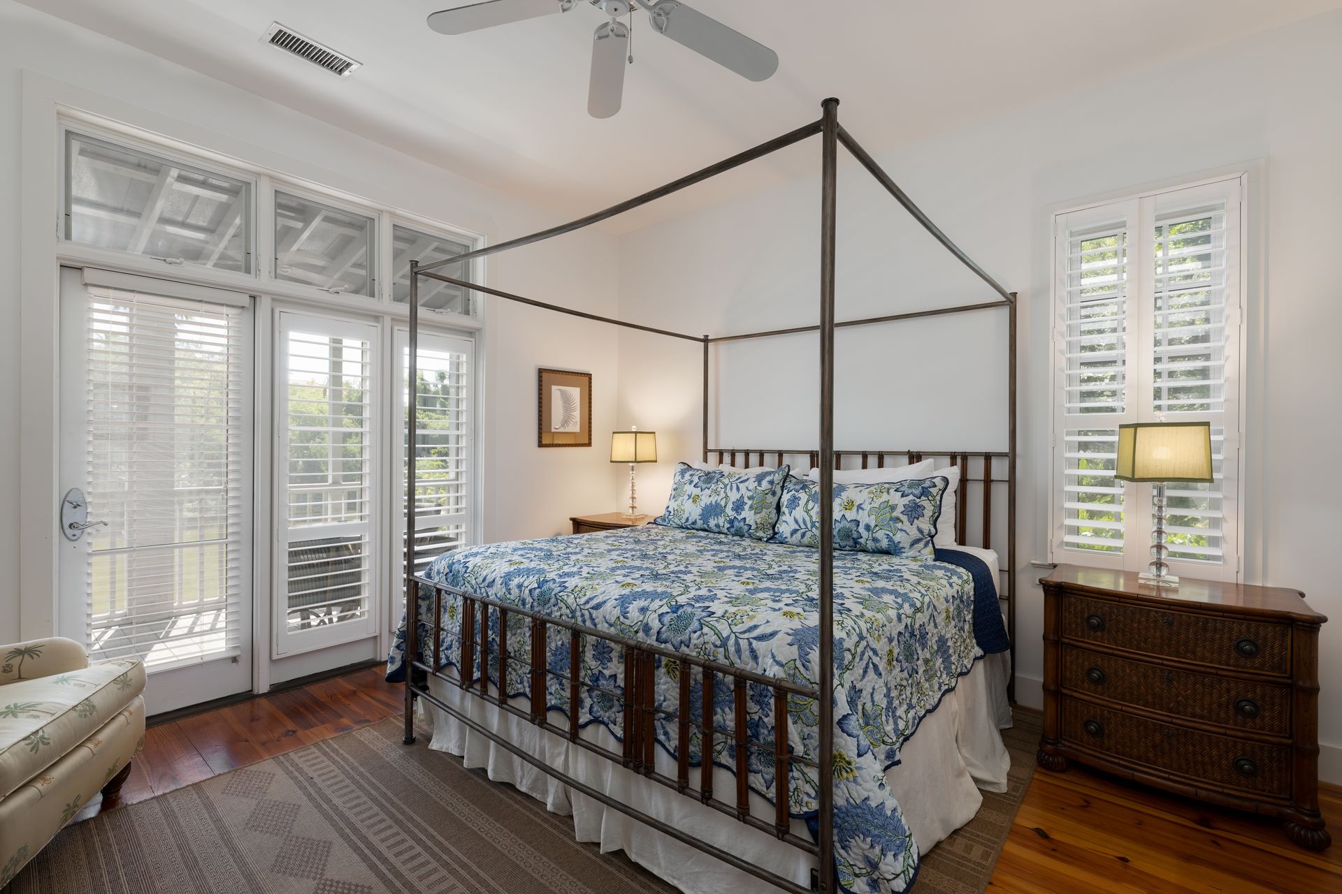 King bed in the master bedroom leading onto the screened in porch