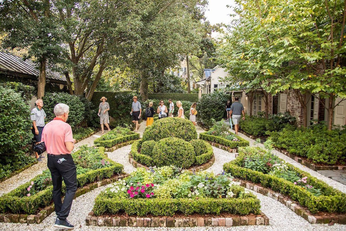 A group of people are standing in a garden.