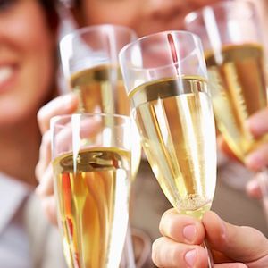 A group of people are toasting with champagne flutes.