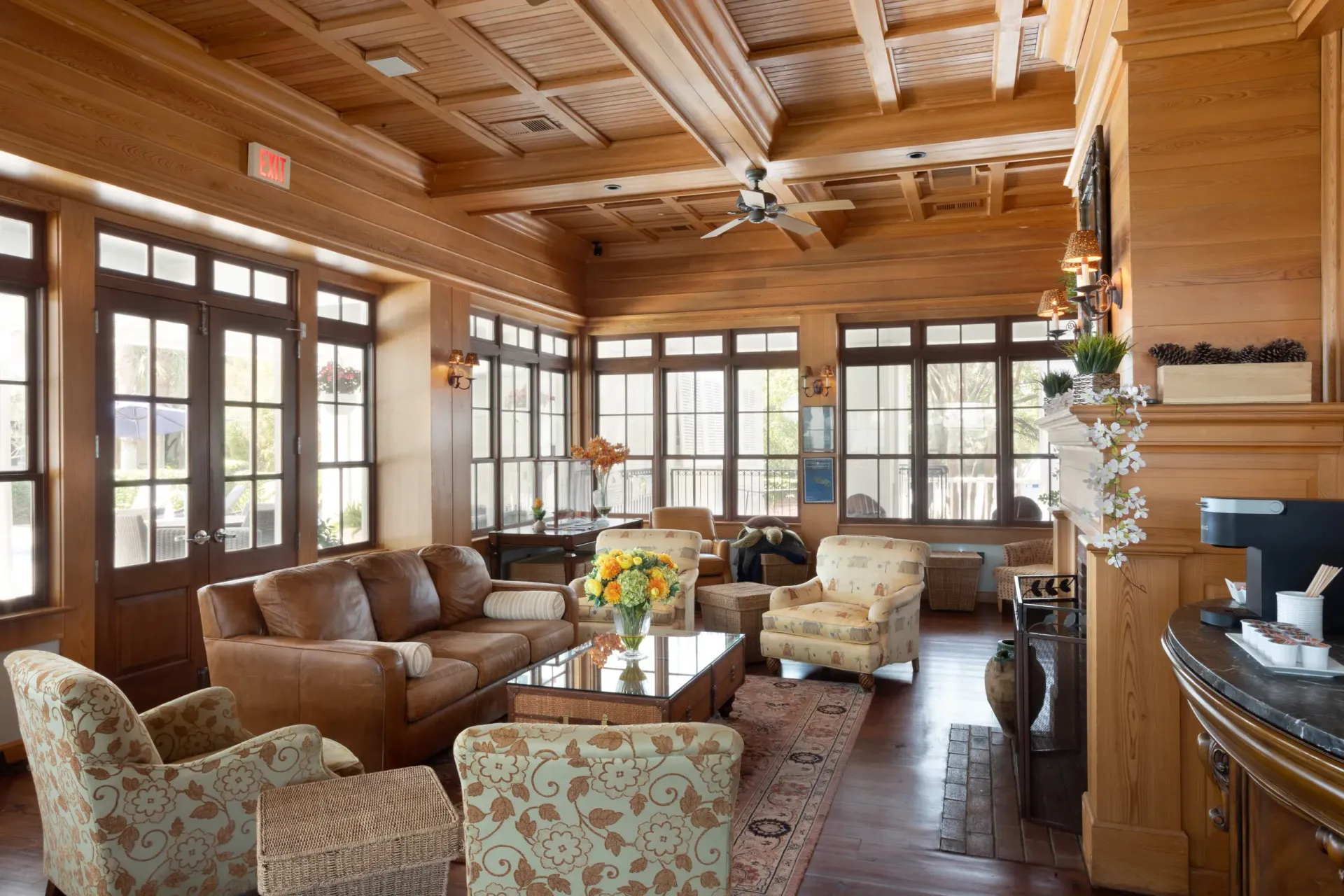 Clubhouse gathering space with couch, comfortable chairs and seasonal fireplace.