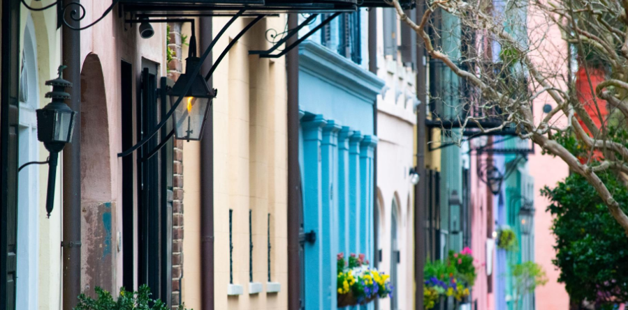 A row of colorful houses on a narrow street.