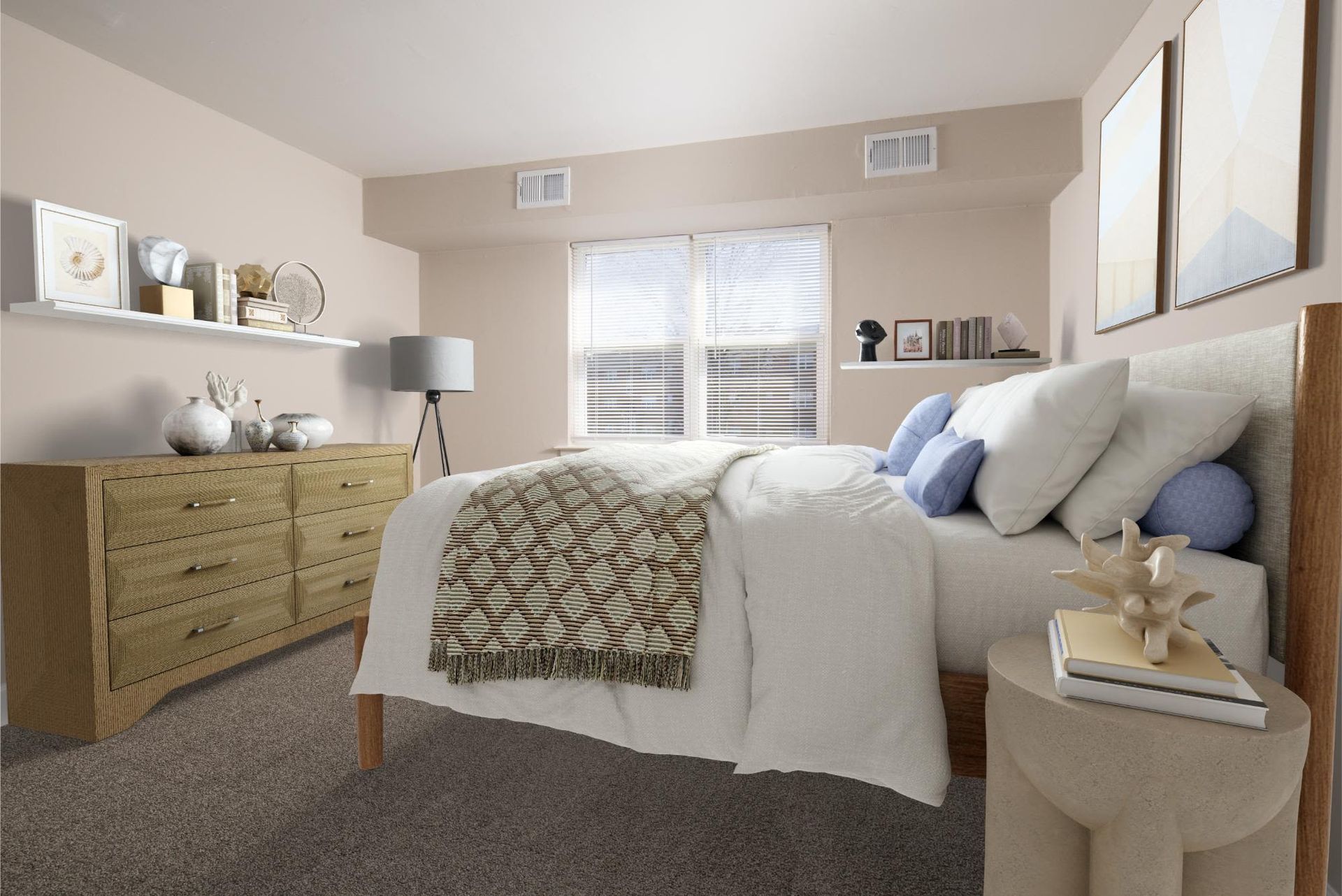 Neutral-toned bedroom in an apartment with a bed, dresser, and window blinds at Liberty Pointe in Newark, DE.