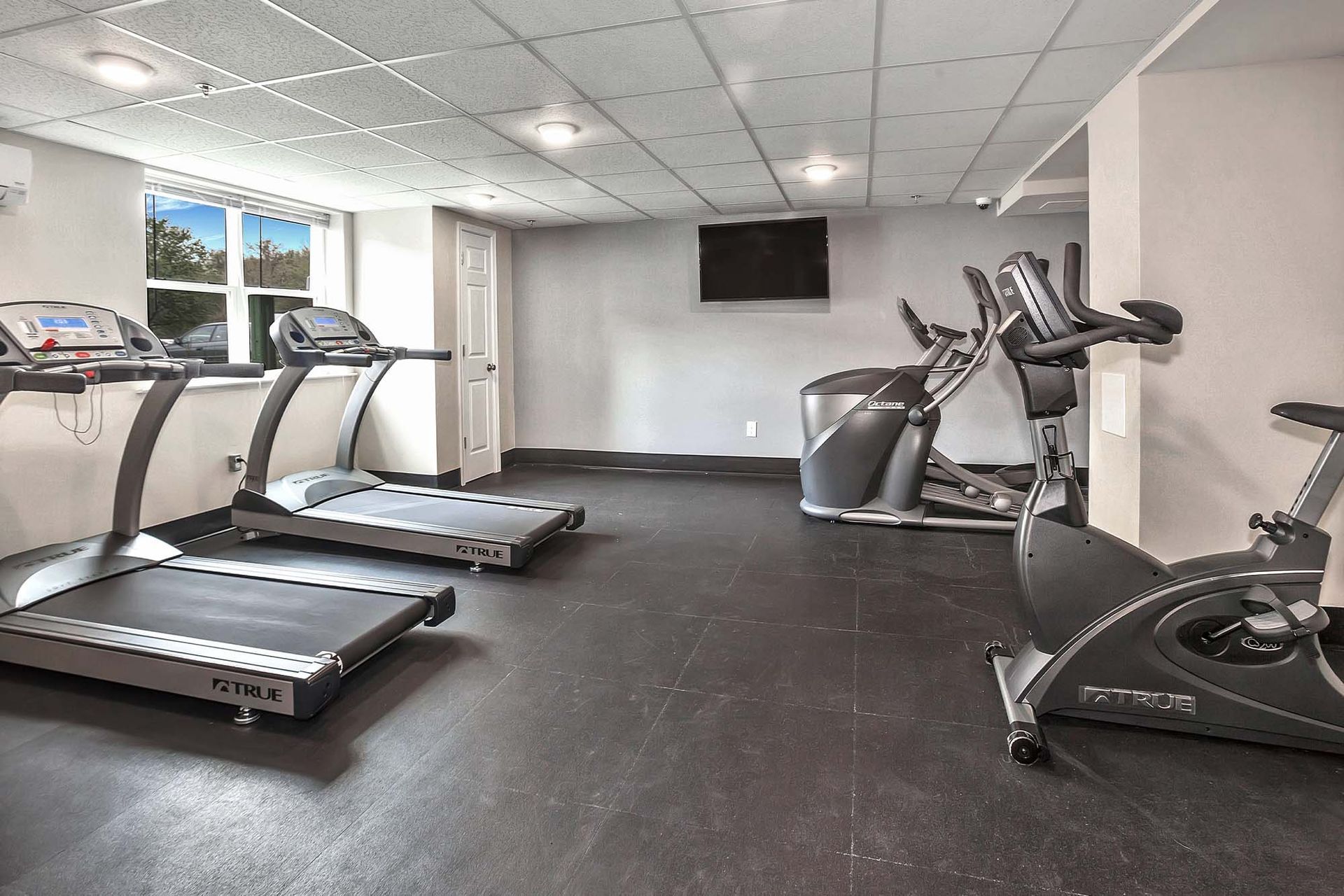 Indoor gym in a residential community with treadmills, elliptical, and a stationary bike at Liberty Pointe in Newark, DE.