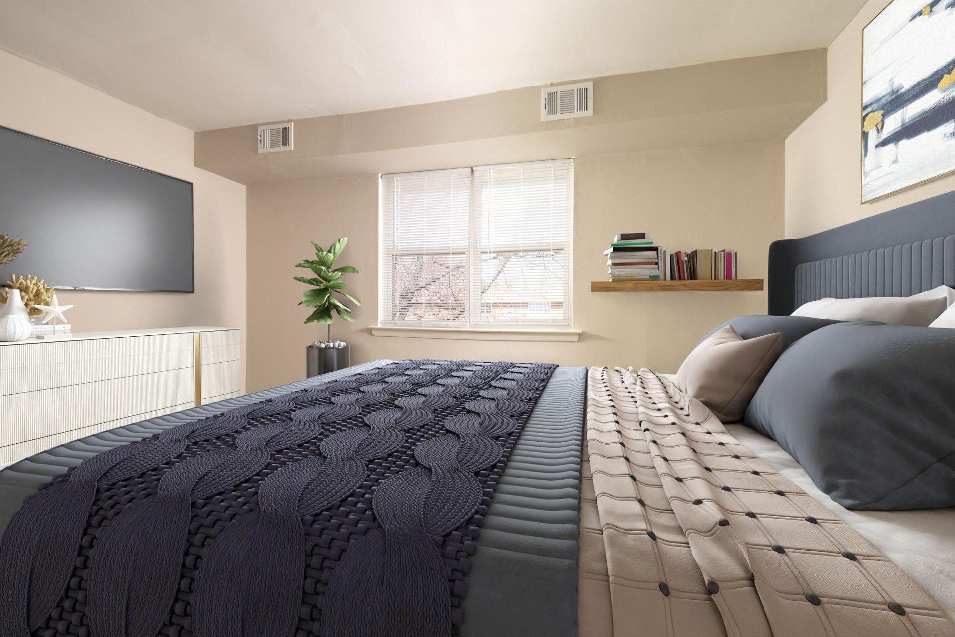 Bedroom in a contemporary apartment with a large bed, wall-mounted TV, dresser, and window at Liberty Pointe in Newark, DE.