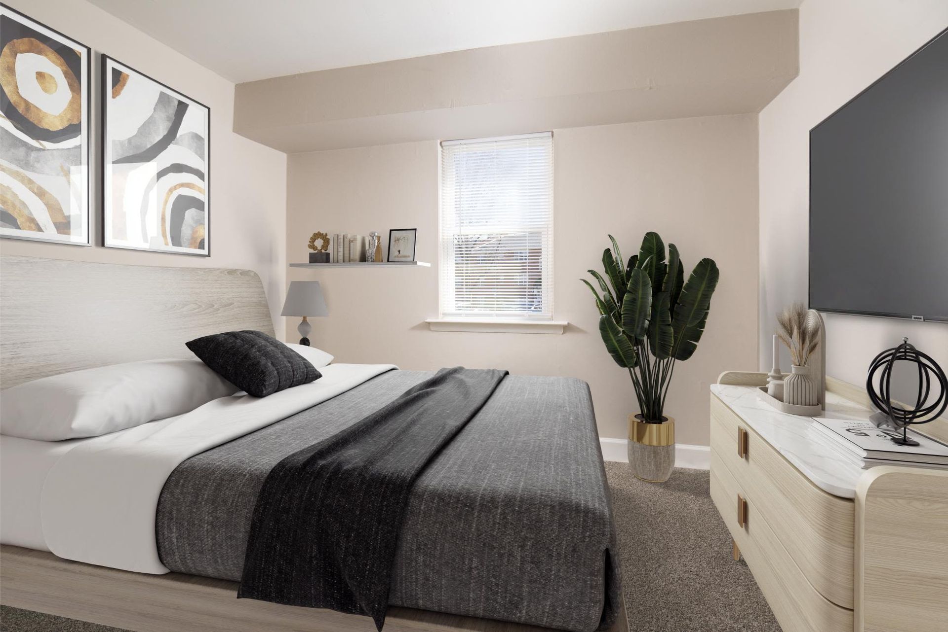 Bedroom with a large bed, dresser, wall-mounted TV, and a potted plant by a window at Liberty Pointe in Newark, DE.