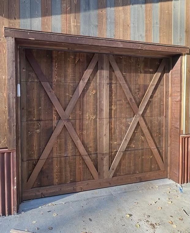 A close up of a wooden garage door with two wooden posts.