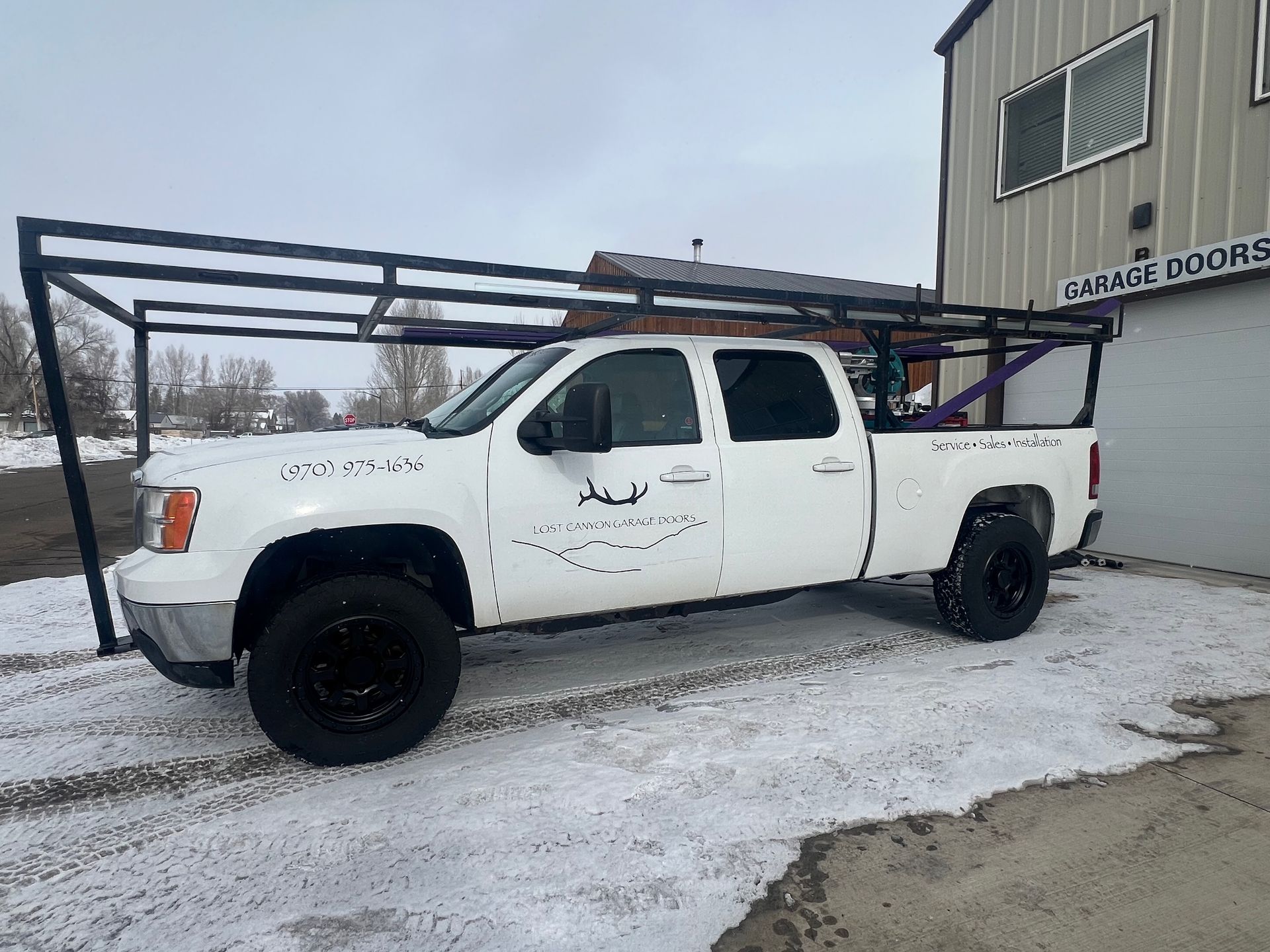 A close up of a wooden garage door with two wooden posts.