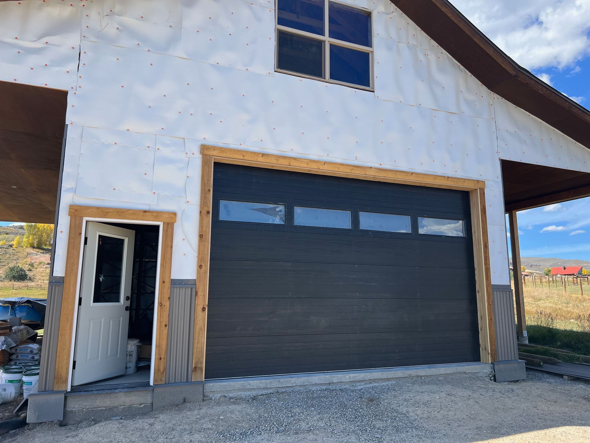 A house with a garage door and a wooden roof.