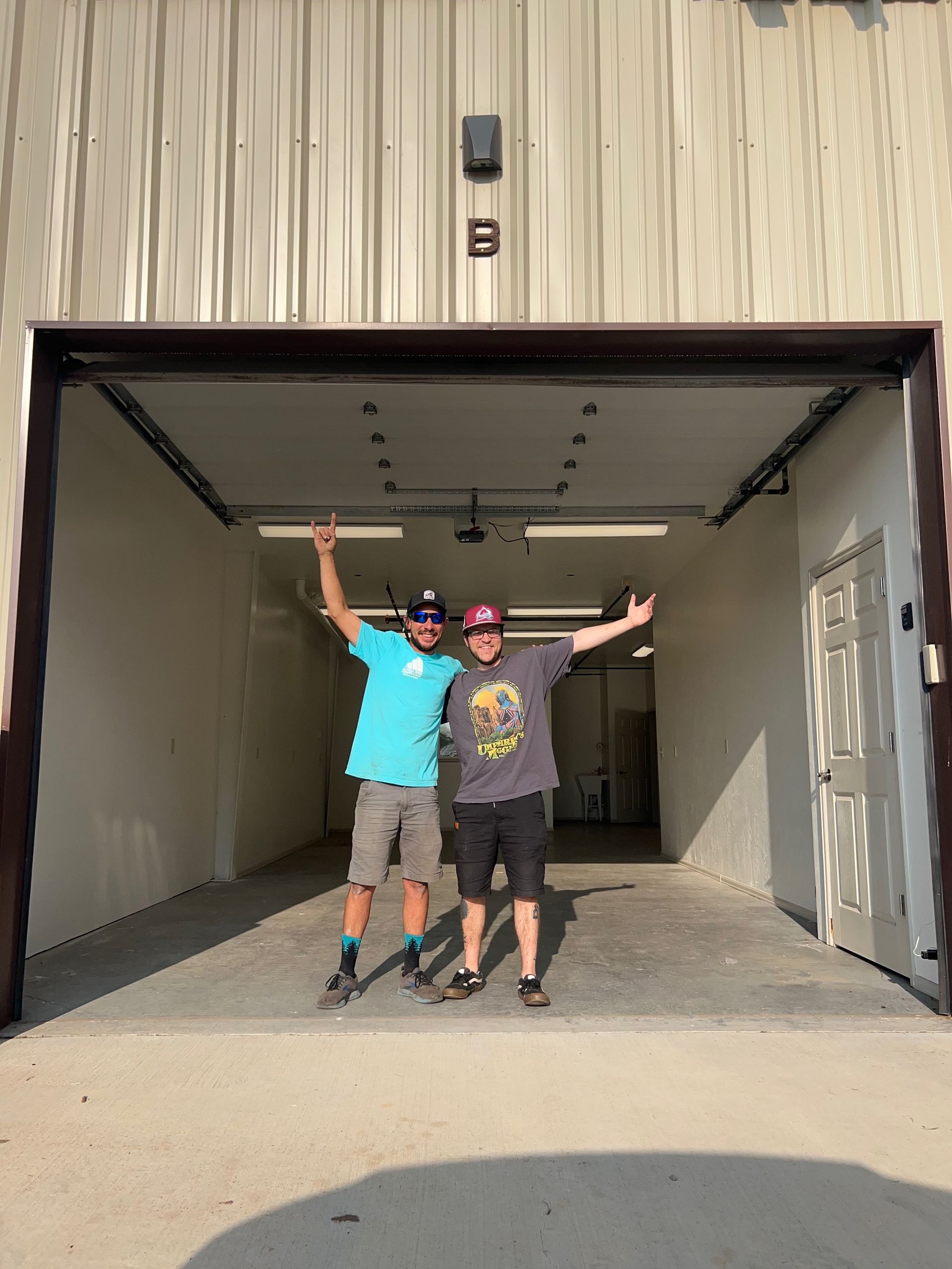 A house with a garage door and a wooden roof.