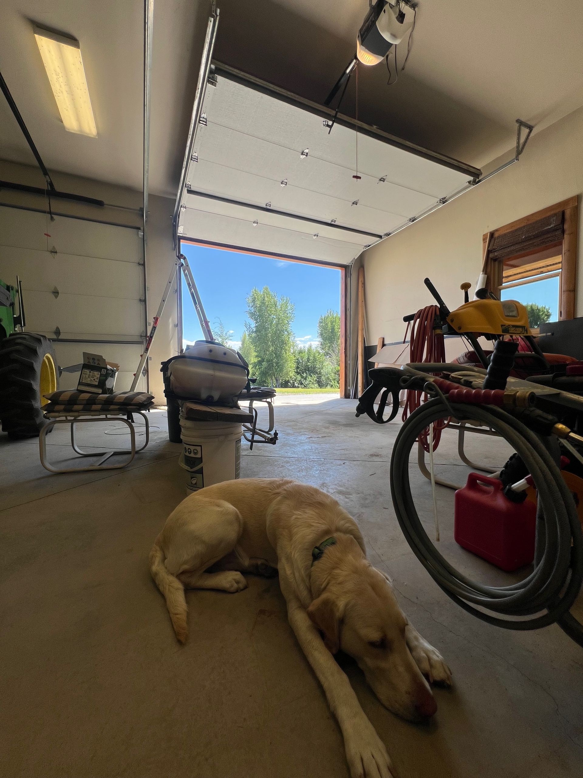 A white house with two black garage doors