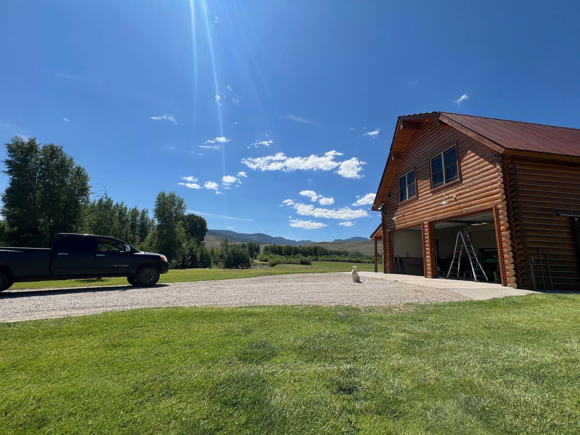 A wooden garage door is sitting in front of a black building.