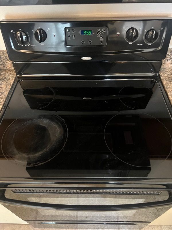 a dirty black stove top oven is sitting on top of a granite counter top .