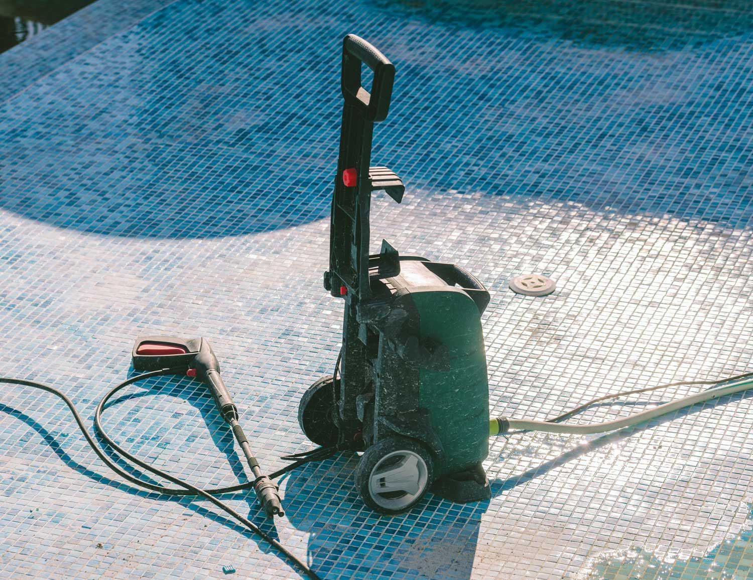 View of a Green Pressure Washing Machine Inside a Pool