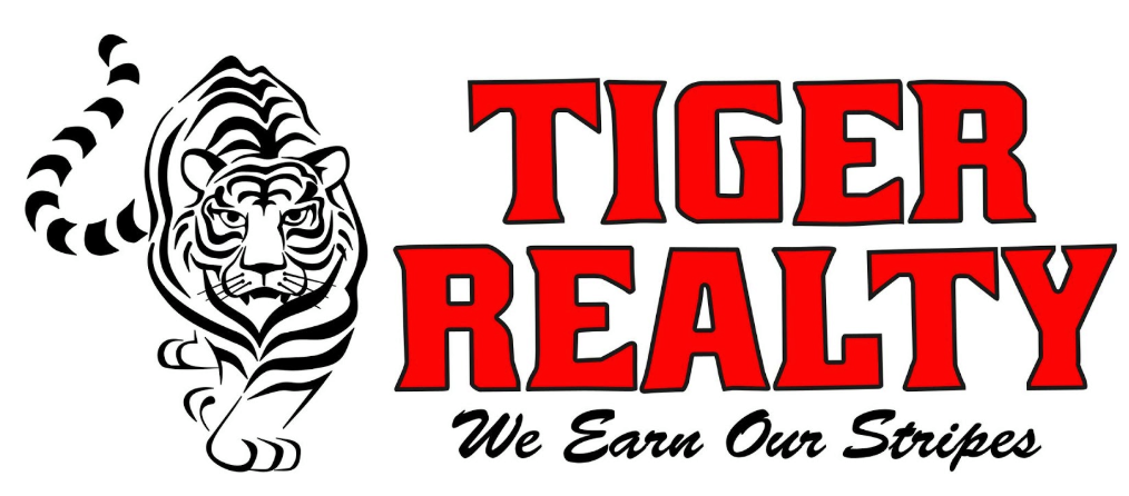 A logo for tiger realty with a tiger on it