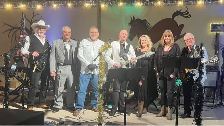 A group of people standing next to each other in front of a bridge.