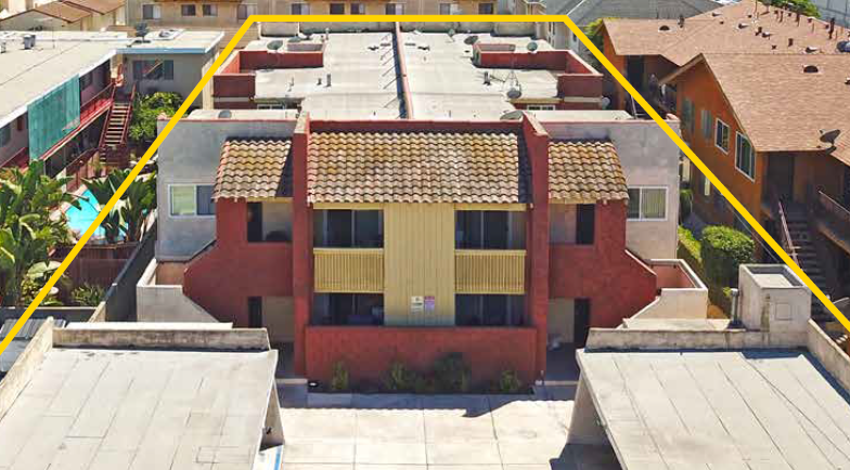An aerial view of a building with a yellow line around it