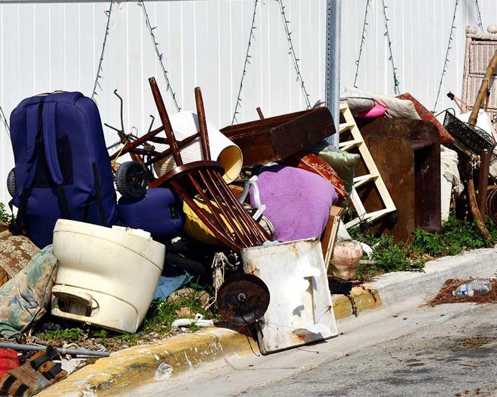 A pile of trash is sitting on the side of the road.