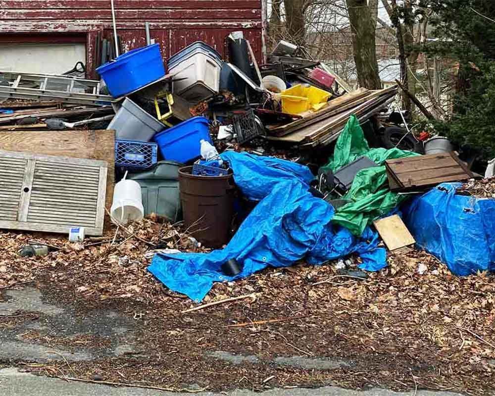 A pile of trash is sitting on the side of the road.
