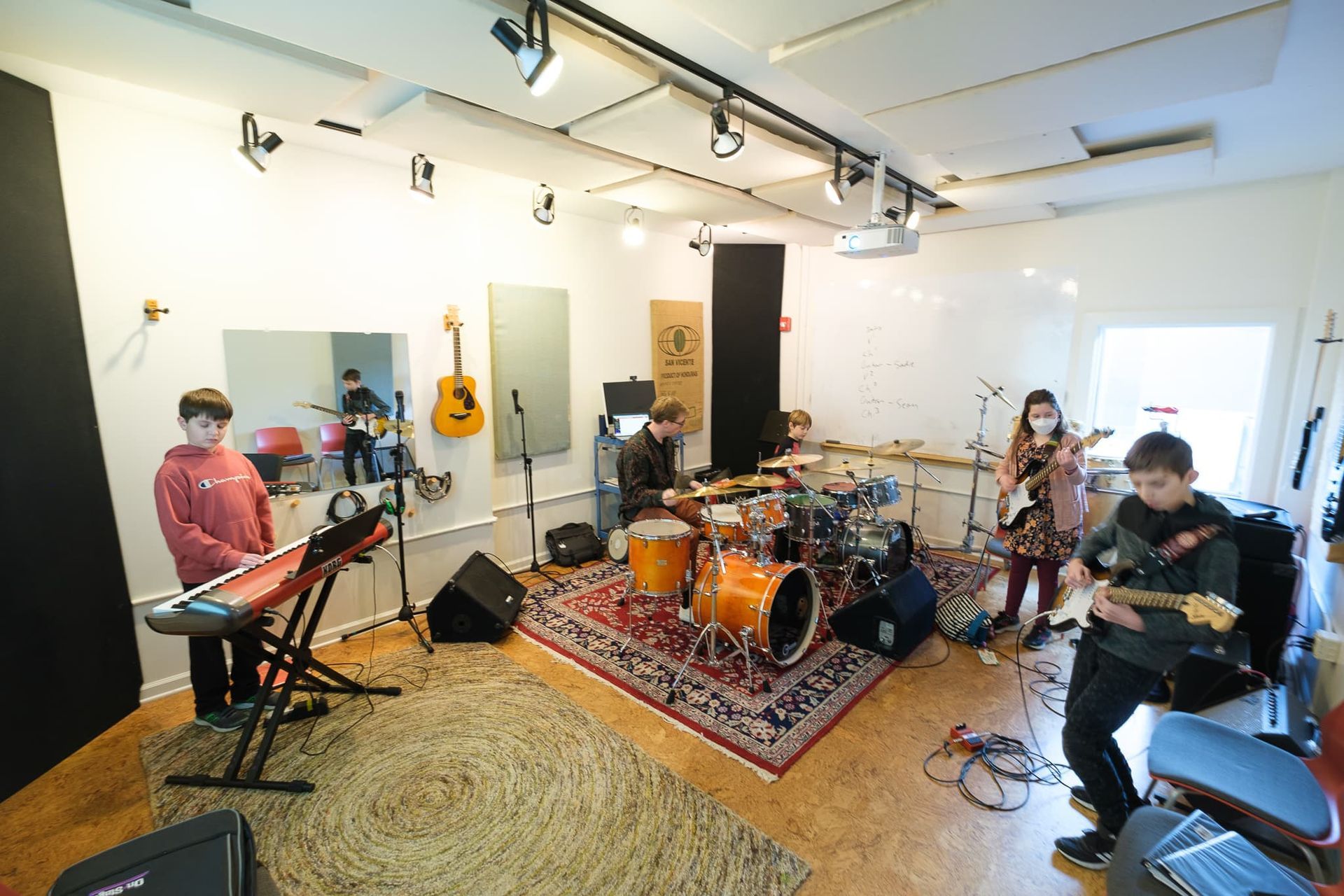 A group of people are playing instruments in a room.