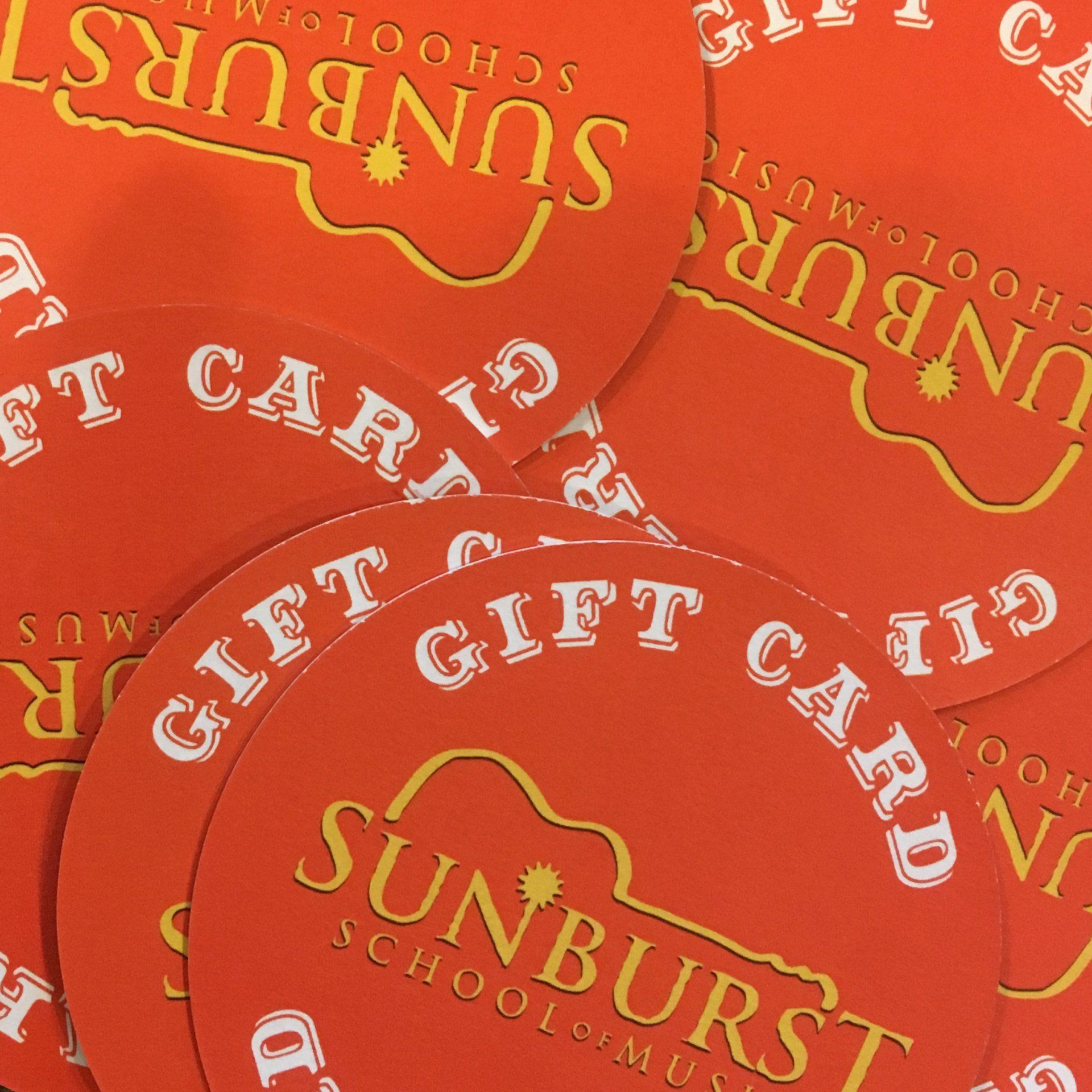 A bunch of sunburst school of music gift cards
