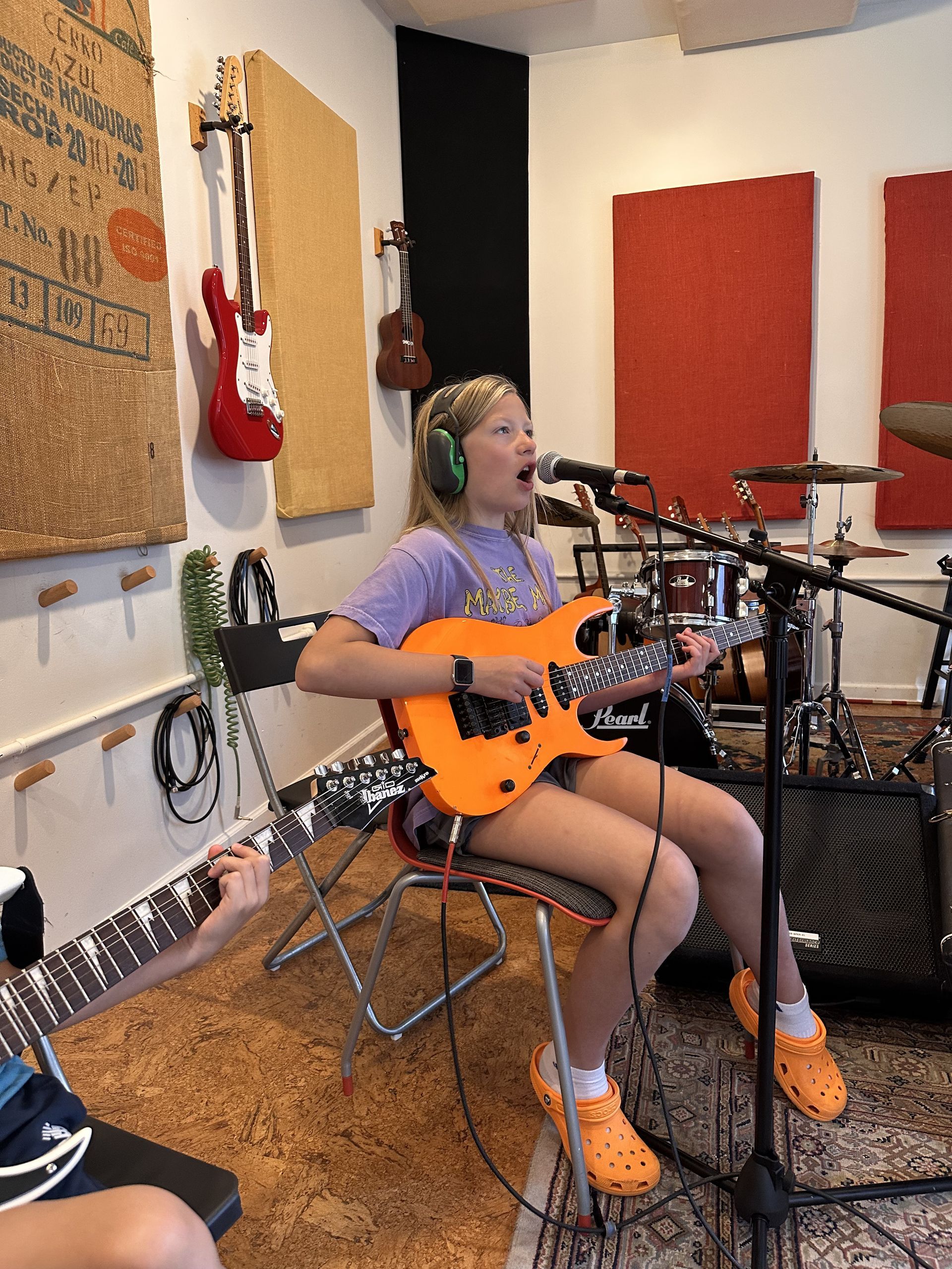 A group of young people are playing instruments on a stage.