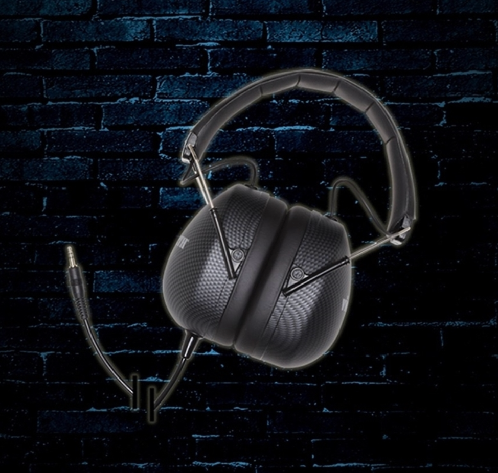 A pair of headphones against a brick wall