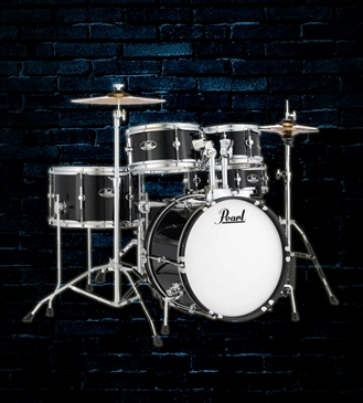 A red drum set is sitting in front of a brick wall.