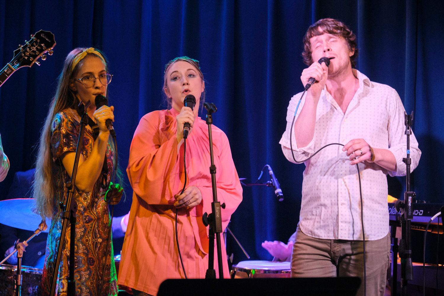 A group of people are playing instruments on a stage.