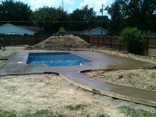 A swimming pool is being built in a backyard