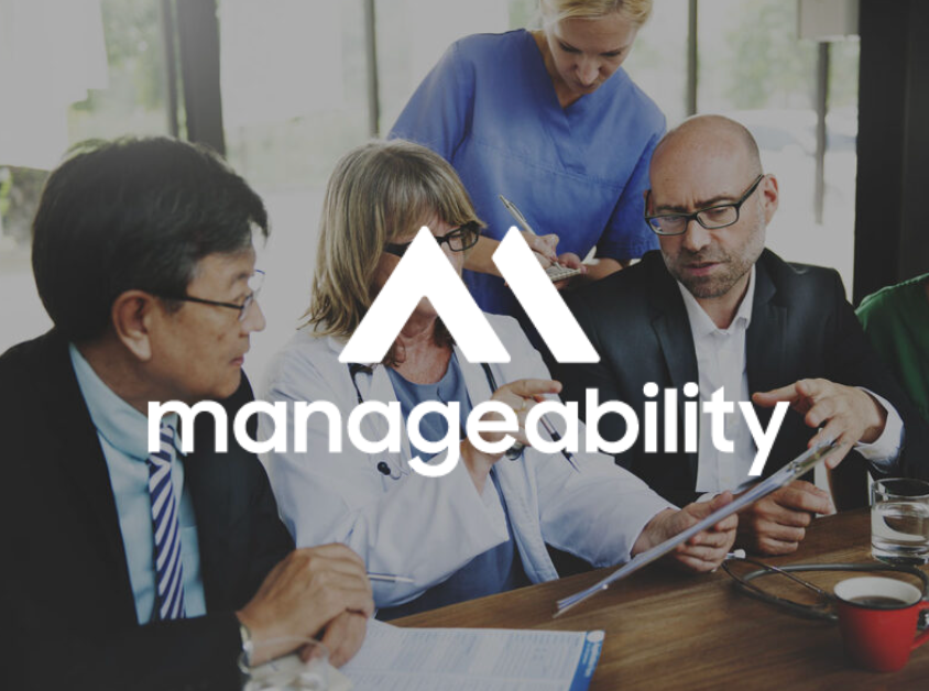 People in a meeting with a logo that says 