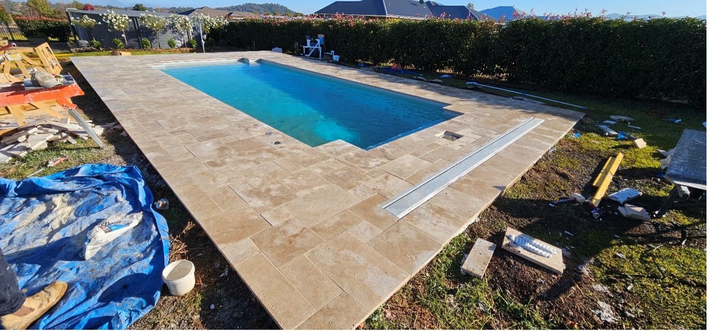A Swimming Pool With A White Shutter On Top Of It — Pool Builder in Moore Creek, NSW