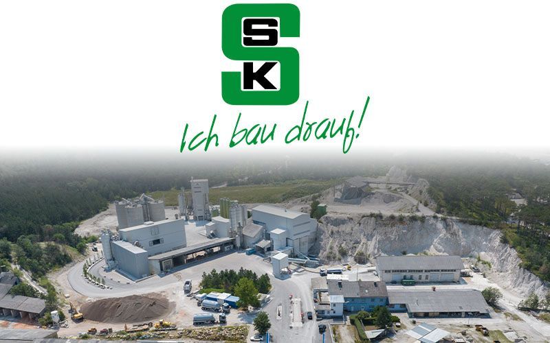 Logo of the company SSK Salzburger Sand & Kieswerke with a gravel plant in the background