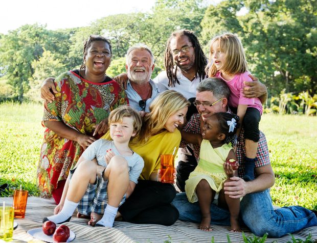 A large family is having a picnic in the park.