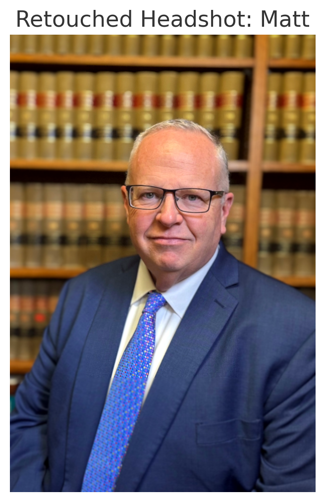 A man in a suit and tie is standing in front of a bookshelf