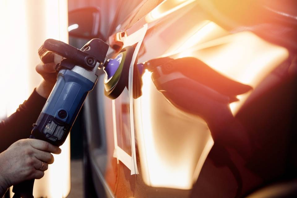 a professional worker working on car detailing and polishing