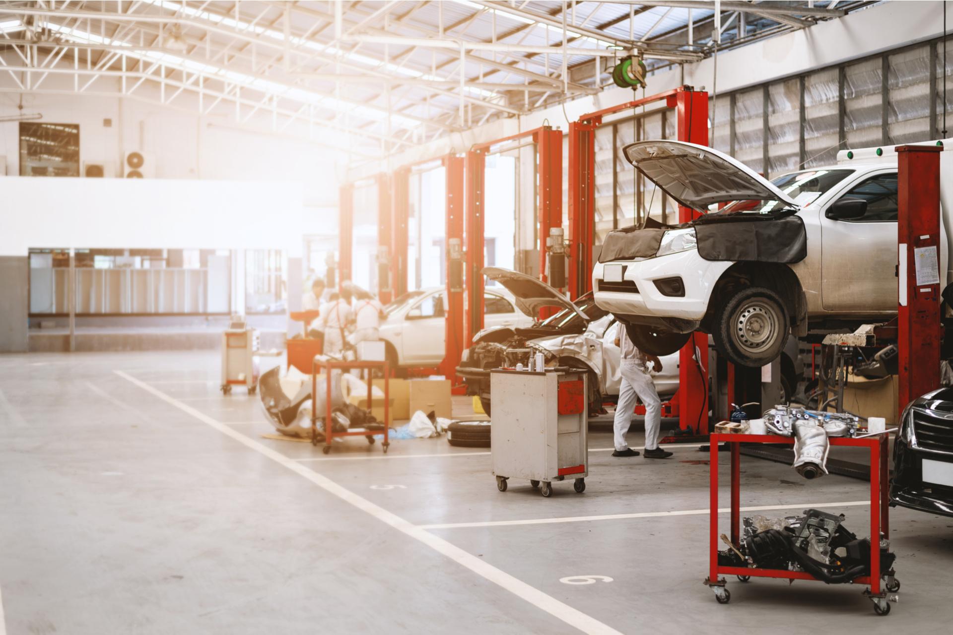 car on the elevator in a repair garage
