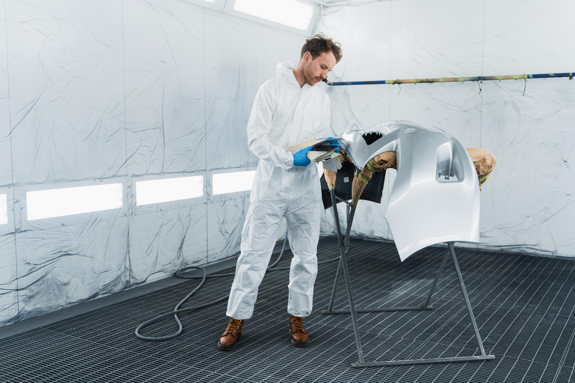 a car worker with a painting gun