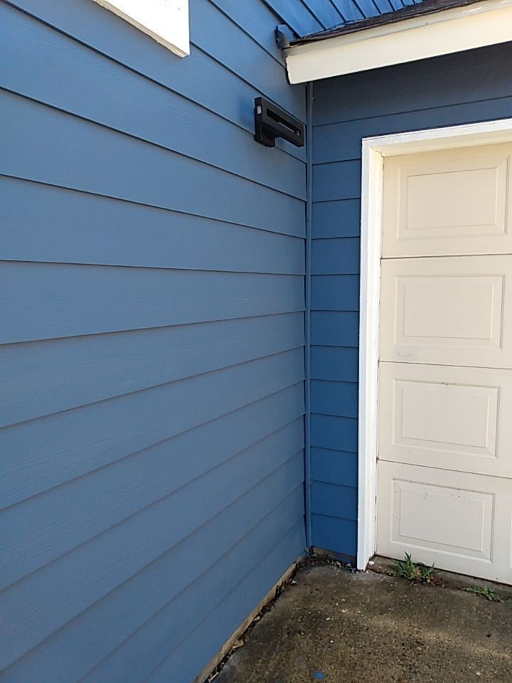 A blue house with a white garage door