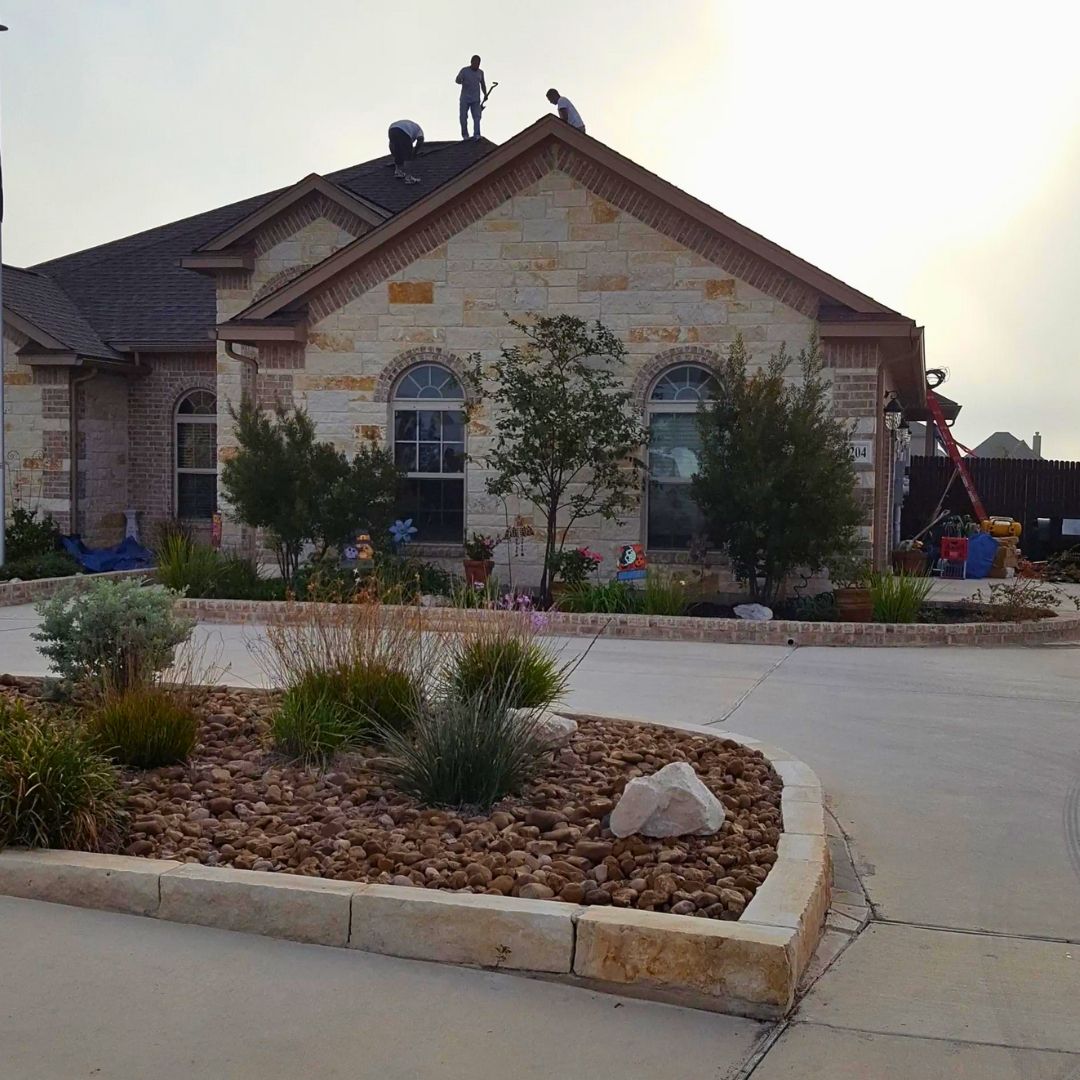 Two men are working on the roof of a house.