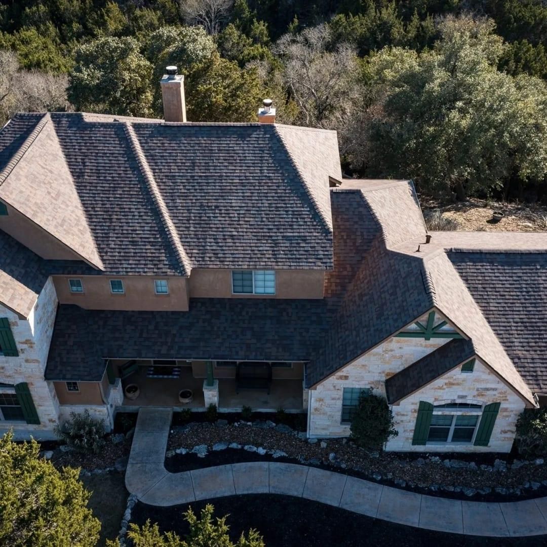 An aerial view of a large house surrounded by trees