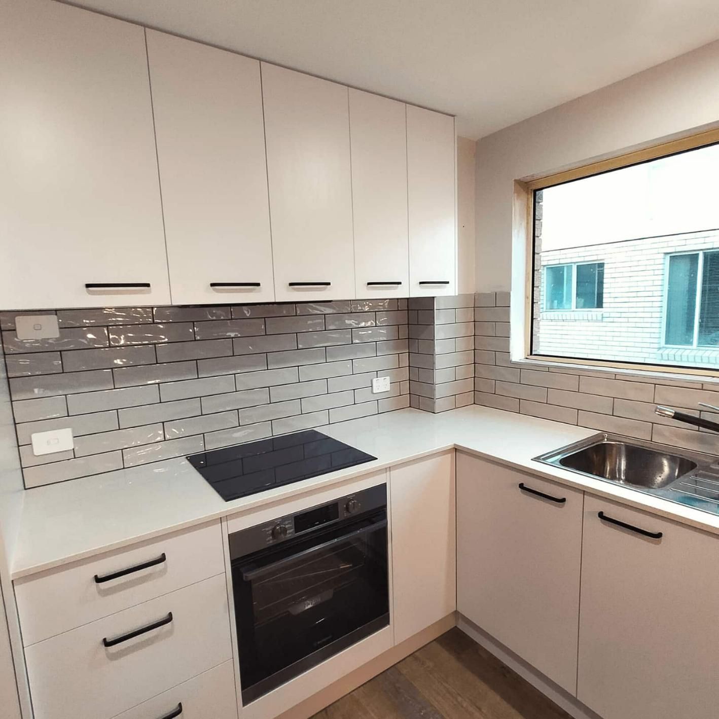 Kitchen With White Cabinets a Sink — Nyblad Construction in Caloundra West, QLD
