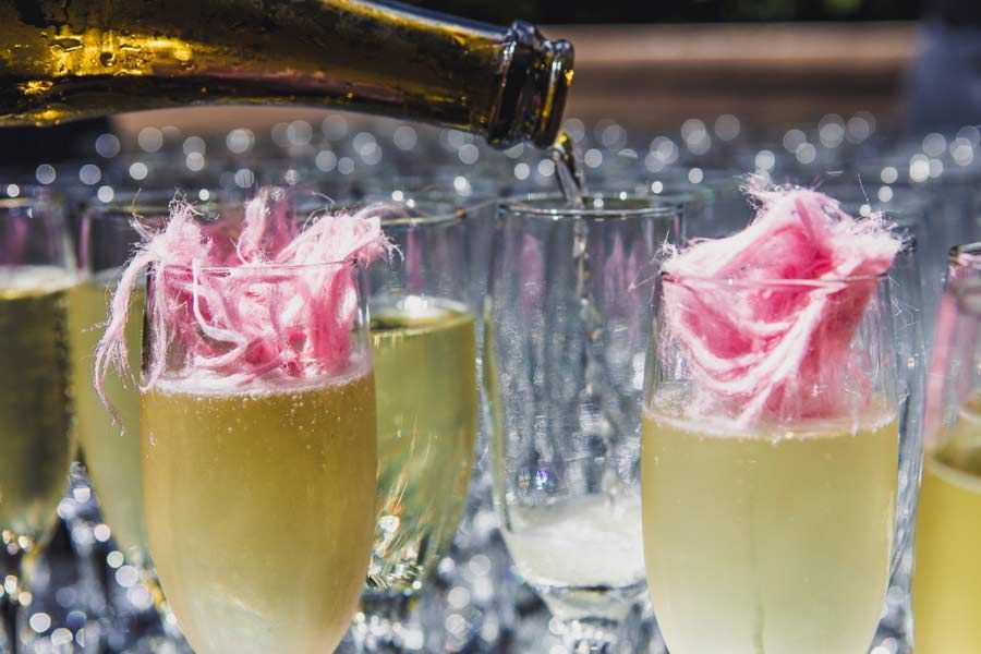 A Bottle Of Champagne Is Being Poured Into A Glass — Nyblad Construction in Caloundra West, QLD