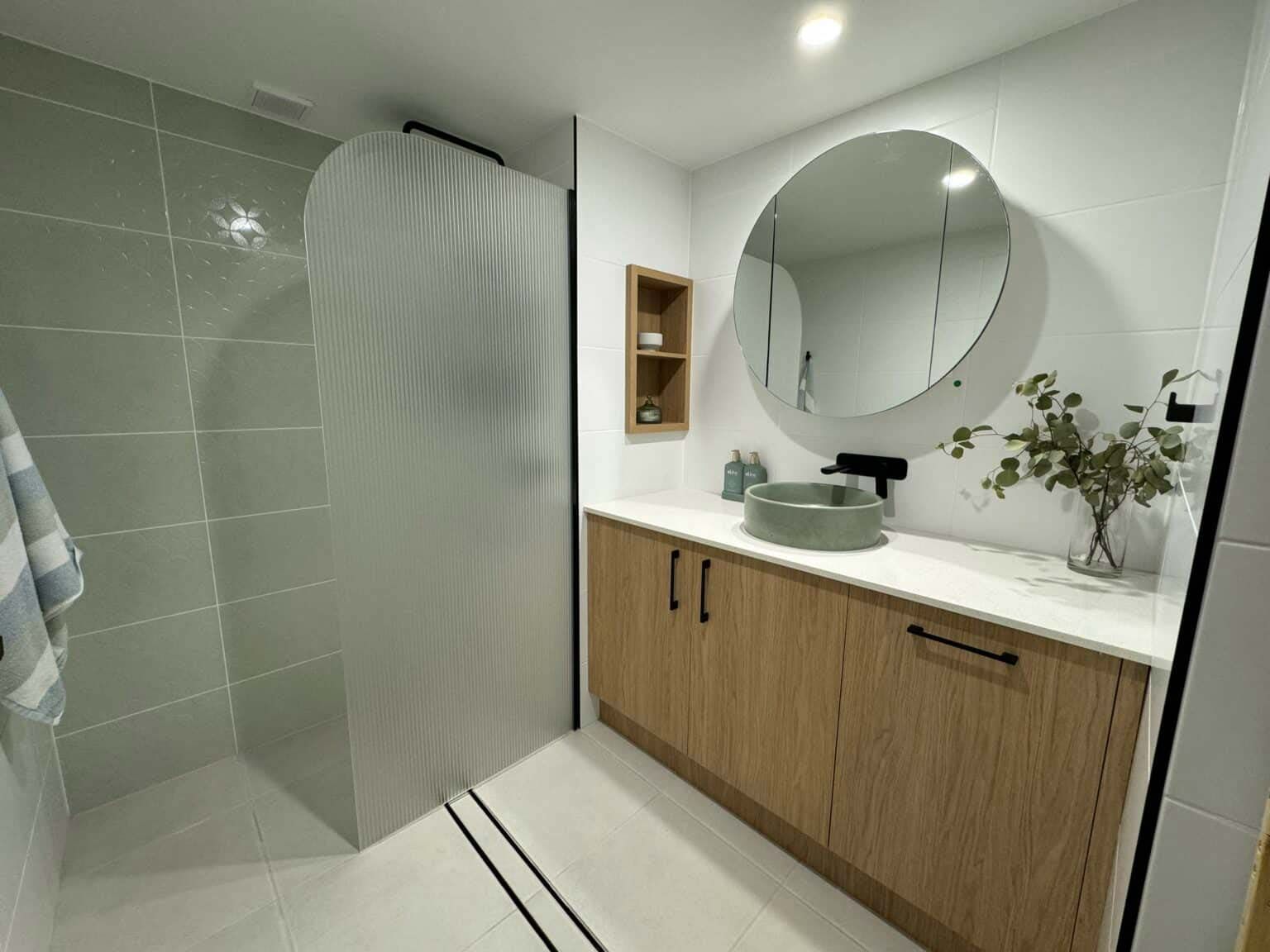 Bathroom Features Hidden Storage Behind The Mirror And Plenty Of Cabinetry — Nyblad Construction in Caloundra West, QLD