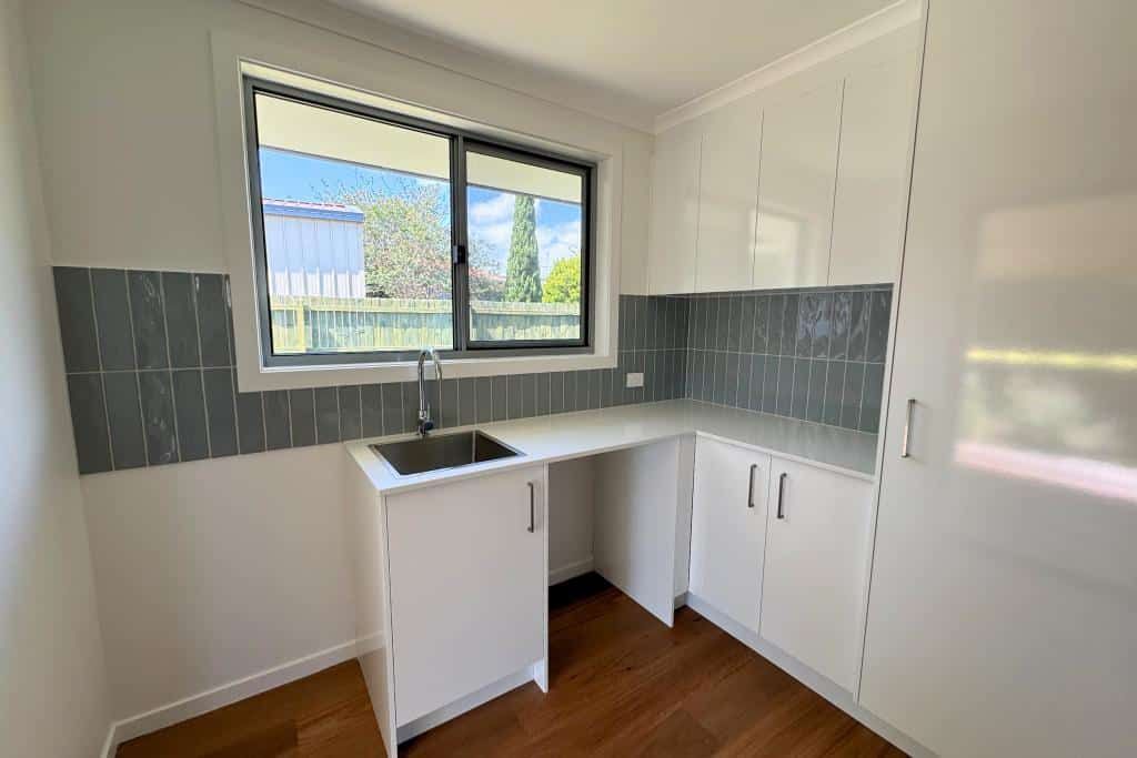 Empty Kitchen With White Cabinets — Nyblad Construction in Caloundra West, QLD