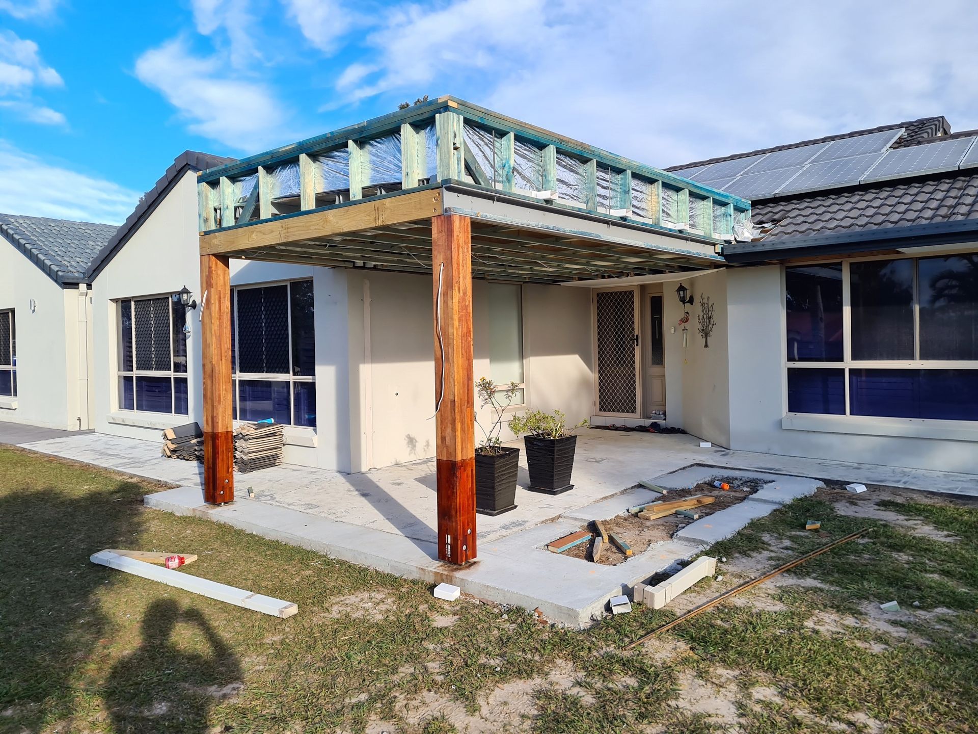 A House Exterior With a Partially Constructed Pergola — Nyblad Construction in Maroochydore, QLD