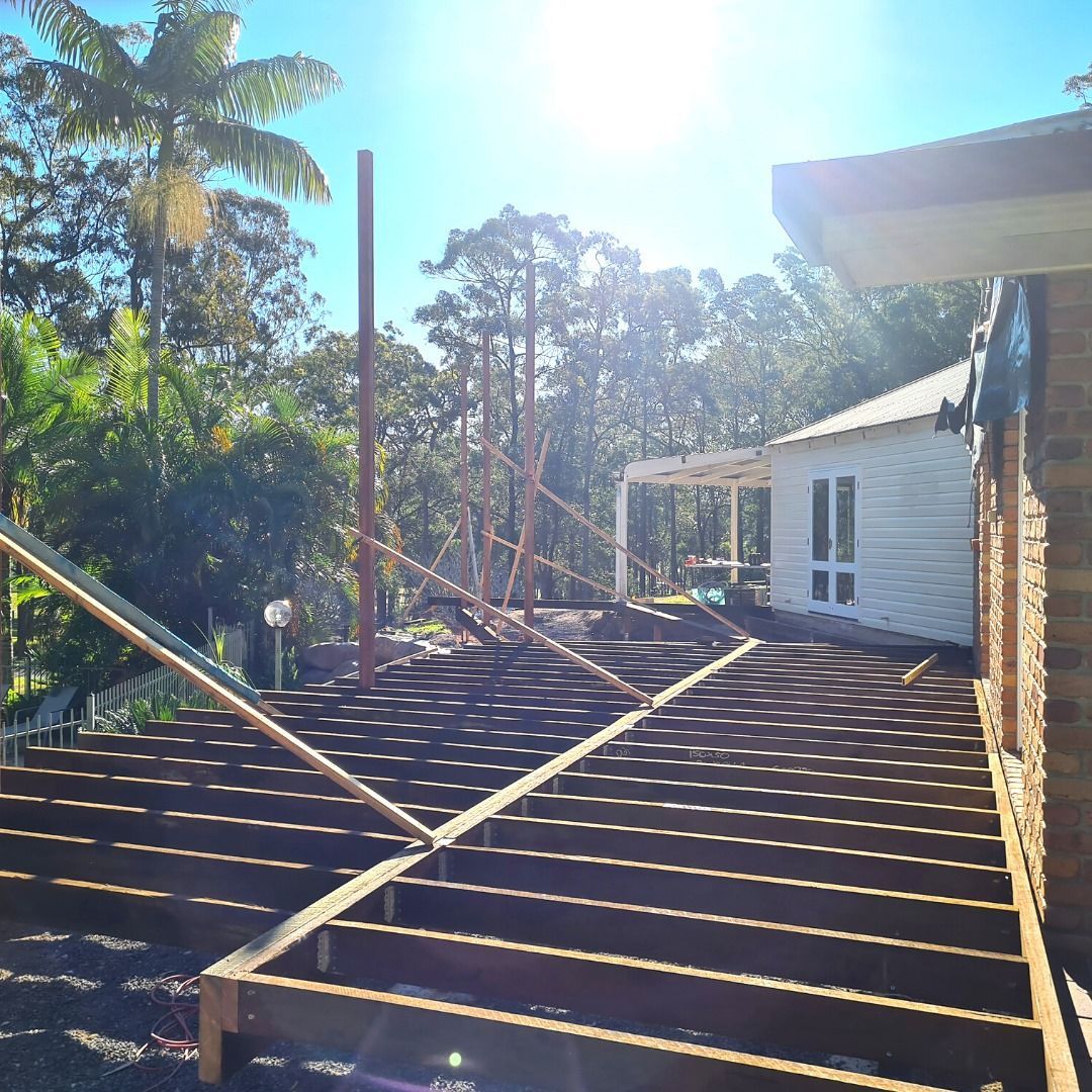 Wooden Deck Under Construction Near a White House — Nyblad Construction in Maroochydore, QLD