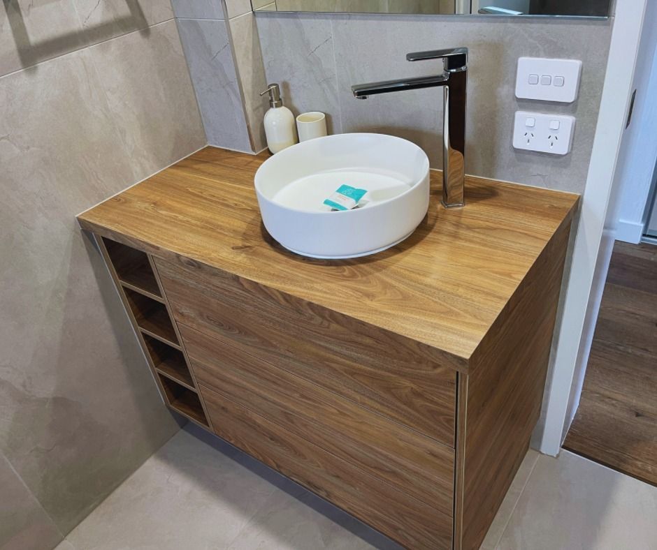 Wooden Bathroom Vanity With a White Bowl Sink, Chrome Faucet, and Storage — Nyblad Construction in Maroochydore, QLD