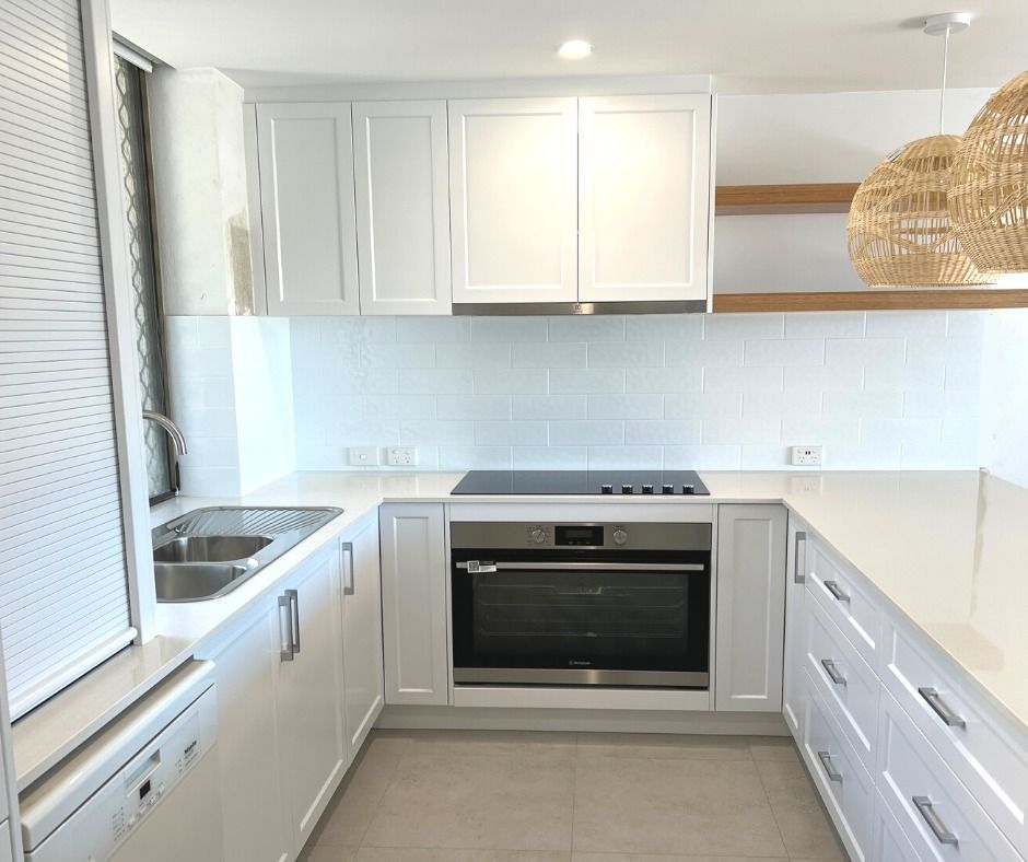 White Kitchen With White Cabinets, Countertops, and Backsplash — Nyblad Construction in Caloundra, QLD