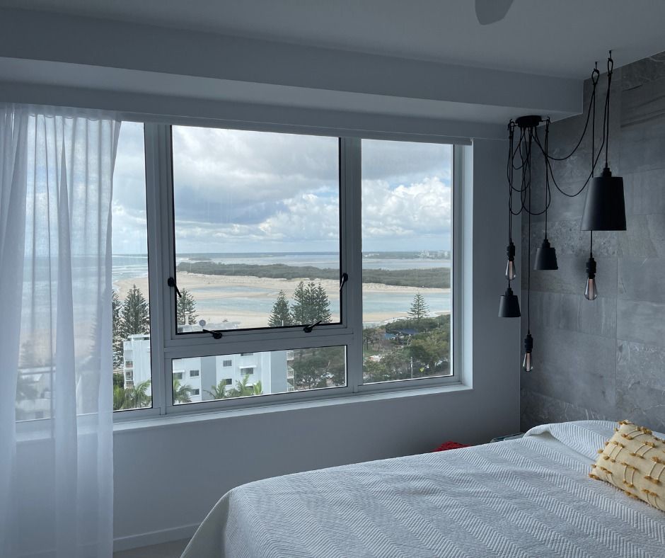 Bedroom With a Large Window Overlooking a Coastal Landscape — Nyblad Construction in Coolum, QLD