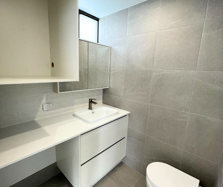 Modern White Bathroom With Grey Tiled Walls — Nyblad Construction in Maroochydore, QLD
